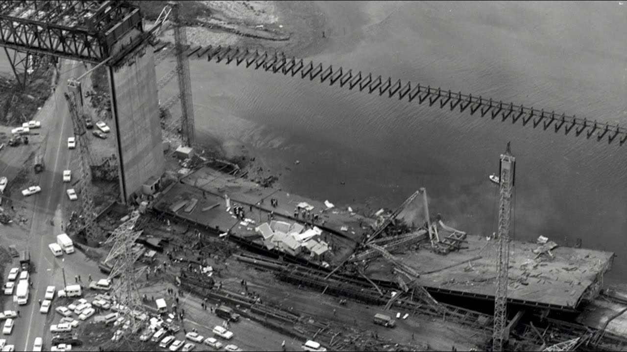 Historic aerial photograph of a collapsed steel bridge span under construction