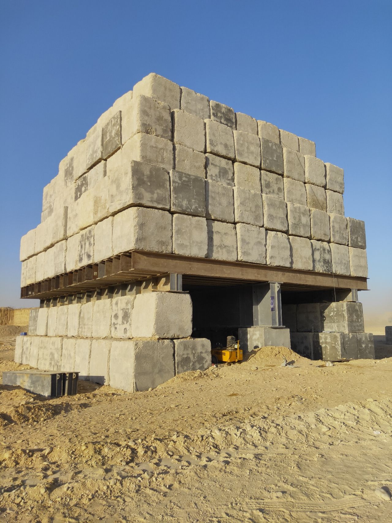 Image of a standard static load pile testing using concrete blocks as dead load