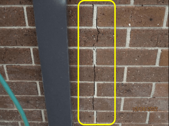 Example of a vertical orientated crack pattern in a masonry wall.  The width and shape of a crack can help tell if a crack is structural.