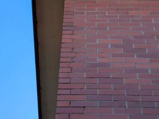 Localised fine cracking through the mortar joints of a brick wall
