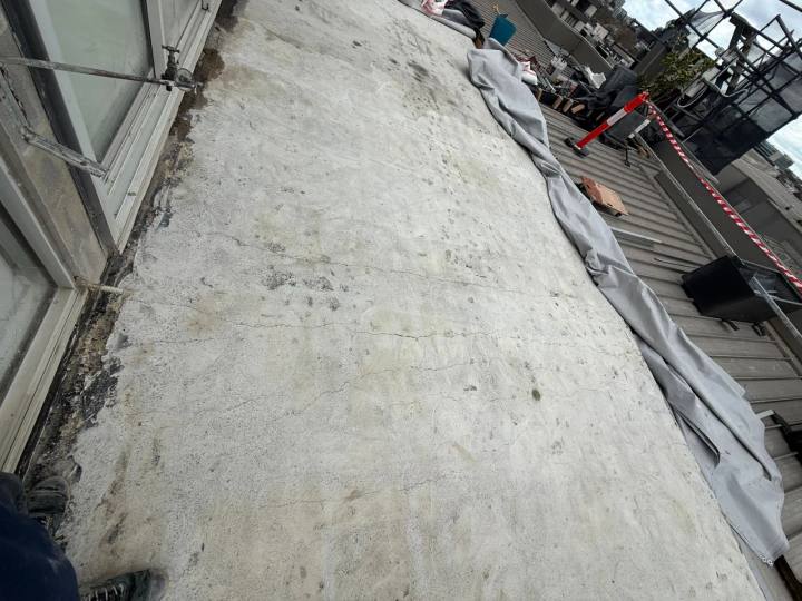 Cracking across an exposed concrete balcony slab during investigation