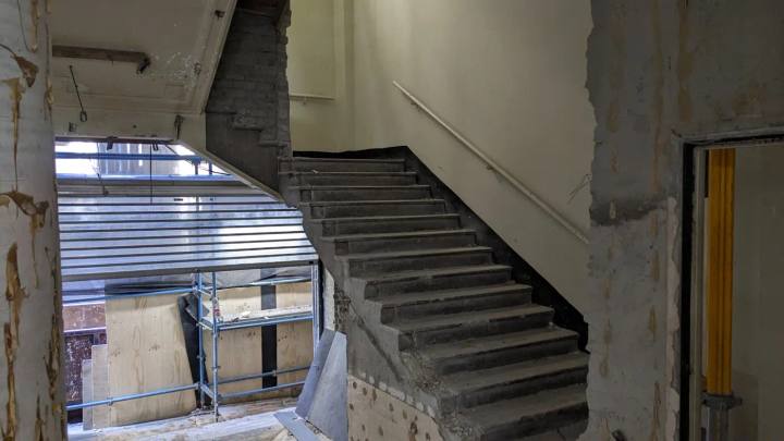 Existing heritage stair partially removed during a new core insertion