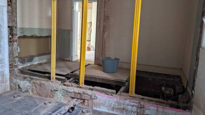 Temporary propping supporting masonry while a new opening is formed